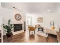 Bright living room featuring fireplace, hardwood floors, and neutral decor at 13020 E Linvale Pl, Aurora, CO 80014
