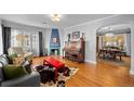 Cozy living room boasts hardwood floors, a decorative fireplace, and an open dining area at 1429 Hudson St, Denver, CO 80220