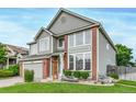 Beautiful two-story home with brick accents, a two-car garage, and landscaped front yard at 20710 E Princeton Pl, Aurora, CO 80013