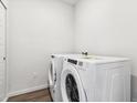 Bright laundry room with stacked washer and dryer at 485 Interlocken Blvd # 201, Broomfield, CO 80021
