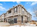 Beautiful townhome featuring a two-car garage, inviting entryway, and architectural details at 9031 Apache Plume Dr # E, Parker, CO 80134