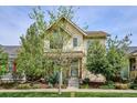 Charming two-story home featuring a welcoming front porch and well-maintained landscaping at 10671 E 28Th Ave, Denver, CO 80238