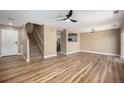 A large living room featuring an open floor plan, with hardwood floors, and a staircase at 817 Pintail Ave, Brighton, CO 80601