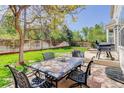 Spacious backyard featuring a large patio with an outdoor dining set, perfect for entertaining and relaxation at 15432 Greenstone Cir, Parker, CO 80134