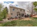 Spacious backyard with patio, perfect for entertaining, featuring lush grass and a fire pit area at 15432 Greenstone Cir, Parker, CO 80134