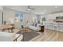Bright and airy living room with modern decor, stylish furniture, and wood flooring at 113 Marlowe Dr, Erie, CO 80516