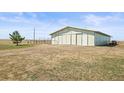 Large barn with sliding doors, perfect for storage or livestock, set on a spacious lot at 43097 Taos Trl, Elizabeth, CO 80107