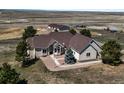 Stunning ranch-style home boasting a well-maintained lawn and tasteful landscaping in a serene countryside setting at 43097 Taos Trl, Elizabeth, CO 80107