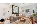 Comfortable living area with a large mirror, plush sofa, and stylish coffee table at 4467 King St, Denver, CO 80211