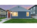 Attractive one-story house with blue siding, complemented by a red front door and a neat green lawn at 1414 W Nevada Pl, Denver, CO 80223