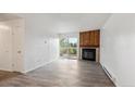 Light-filled living room with fireplace, sliding door access to the balcony, and neutral paint at 14700 E Kentucky Dr # 524, Aurora, CO 80012