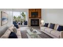 Inviting living room with fireplace, plush sofas, and access to a private balcony at 14700 E Kentucky Dr # 524, Aurora, CO 80012