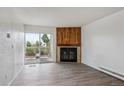 Bright living room with a sliding glass door and a fireplace with decorative tile at 14700 E Kentucky Dr # 524, Aurora, CO 80012