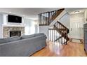 Living room with hardwood floors, fireplace and stairs at 1370 S Idalia St # C, Aurora, CO 80017