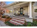 Inviting front porch with rocking chairs, perfect for relaxing at 1825 Albion St, Denver, CO 80220