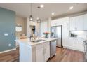 Stylish kitchen with white cabinetry, stainless appliances, and a large island at 400 E Fremont Pl # 207, Centennial, CO 80122