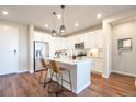 Bright kitchen features stainless steel appliances, quartz counters, and hardwood floors at 400 E Fremont Pl # 207, Centennial, CO 80122