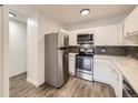 Updated kitchen with stainless steel appliances and white cabinets at 750 S Clinton St # 2C, Denver, CO 80247