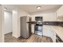Modern kitchen with stainless steel appliances and gray subway tile backsplash at 750 S Clinton St # 2C, Denver, CO 80247