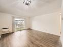 Spacious living area with hardwood floors and access to a private balcony at 750 S Clinton St # 2C, Denver, CO 80247