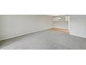 Large living room with gray carpet, and view of kitchen at 7395 E Quincy Ave # 207, Denver, CO 80237