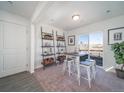 Bright dining area features a modern table set, a sliding glass door, and modern shelving at 13548 E 103Rd Pl, Commerce City, CO 80022