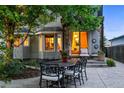 Inviting backyard with patio area for outdoor dining and a glimpse of the home's interior at 505 Orchard Dr, Louisville, CO 80027