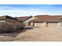 Charming home featuring a two-car garage, a well-kept driveway, and a lush yard at 7679 S Biloxi Way, Aurora, CO 80016