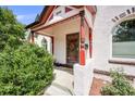 Inviting front porch with decorative columns and charming architectural details at 3106 N Franklin St, Denver, CO 80205