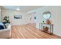 Bright living room features hardwood floors, neutral paint, and ample natural light at 366 Kenton St, Aurora, CO 80010