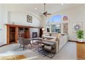Bright living room featuring hardwood floors and a fireplace at 486 S Youngfield Cir, Lakewood, CO 80228