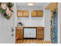 Charming butler's pantry area with cabinets, counter space, coffee maker, and stylish decor at 8674 Carr Loop, Arvada, CO 80005