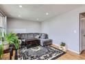 Cozy living room featuring a comfortable gray sectional sofa and area rug at 1325 Elder St, Denver, CO 80221