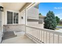 Charming covered porch showcasing detailed trim and natural light, and a glimpse of the spacious driveway at 11853 Trail View Ln, Parker, CO 80134