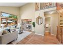 Inviting living room boasts soaring ceilings, large windows, and an open floor plan at 11932 W 56Th Cir, Arvada, CO 80002