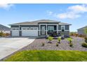 Beautiful home with a three car garage, stone accents, and a cozy front patio at 15640 Spruce St, Thornton, CO 80602