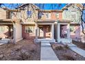 Attractive townhomes with brick and siding exteriors, each featuring a covered front porch entrance at 7352 E 7Th Ave # 7, Denver, CO 80230