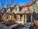 Attractive exterior view of townhomes with brick accents, covered porches, and well-maintained landscaping at 7352 E 7Th Ave # 7, Denver, CO 80230
