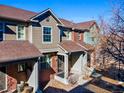 Charming townhome featuring a mix of brick and brown siding with a cozy covered front porch at 7352 E 7Th Ave # 7, Denver, CO 80230