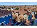 A picturesque aerial view of townhomes showcasing a charming neighborhood with mountain views in the background at 7352 E 7Th Ave # 7, Denver, CO 80230