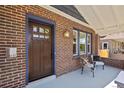 Inviting front porch featuring stylish seating, brick accents, and a classic wood door at 3332 N Vine St, Denver, CO 80205