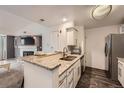 Modern kitchen with stainless steel appliances, granite countertops, and an adjacent living area at 9510 E Florida Ave # 3055, Denver, CO 80247