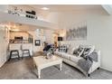 Bright living room with high ceilings, an open floorplan, and a loft space above at 9510 E Florida Ave # 3055, Denver, CO 80247