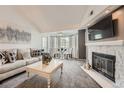 Cozy living room with a fireplace, TV, and adjacent dining area with bay windows at 9510 E Florida Ave # 3055, Denver, CO 80247