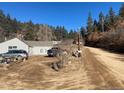 Rustic home with a long gravel driveway at 1805 Hidden Valley Rd, Sedalia, CO 80135