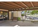 Welcoming covered entrance featuring a bench, accessible ramp, and views of the surrounding greenery at 7000 E Quincy Ave # 302, Denver, CO 80237