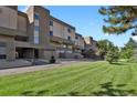 Attractive condo building featuring well-maintained lawn, mature trees, and inviting exterior elevation at 7000 E Quincy Ave # 302, Denver, CO 80237