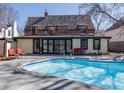 A refreshing backyard pool with patio seating offers an ideal spot for relaxation and entertaining in the sunshine at 629 Bellaire St, Denver, CO 80220