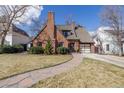 Beautiful brick home with a manicured front lawn, stone pathway, and attached garage creates a welcoming curb appeal at 629 Bellaire St, Denver, CO 80220