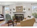 Cozy living room with a fireplace, hardwood floors, and natural light at 629 Bellaire St, Denver, CO 80220